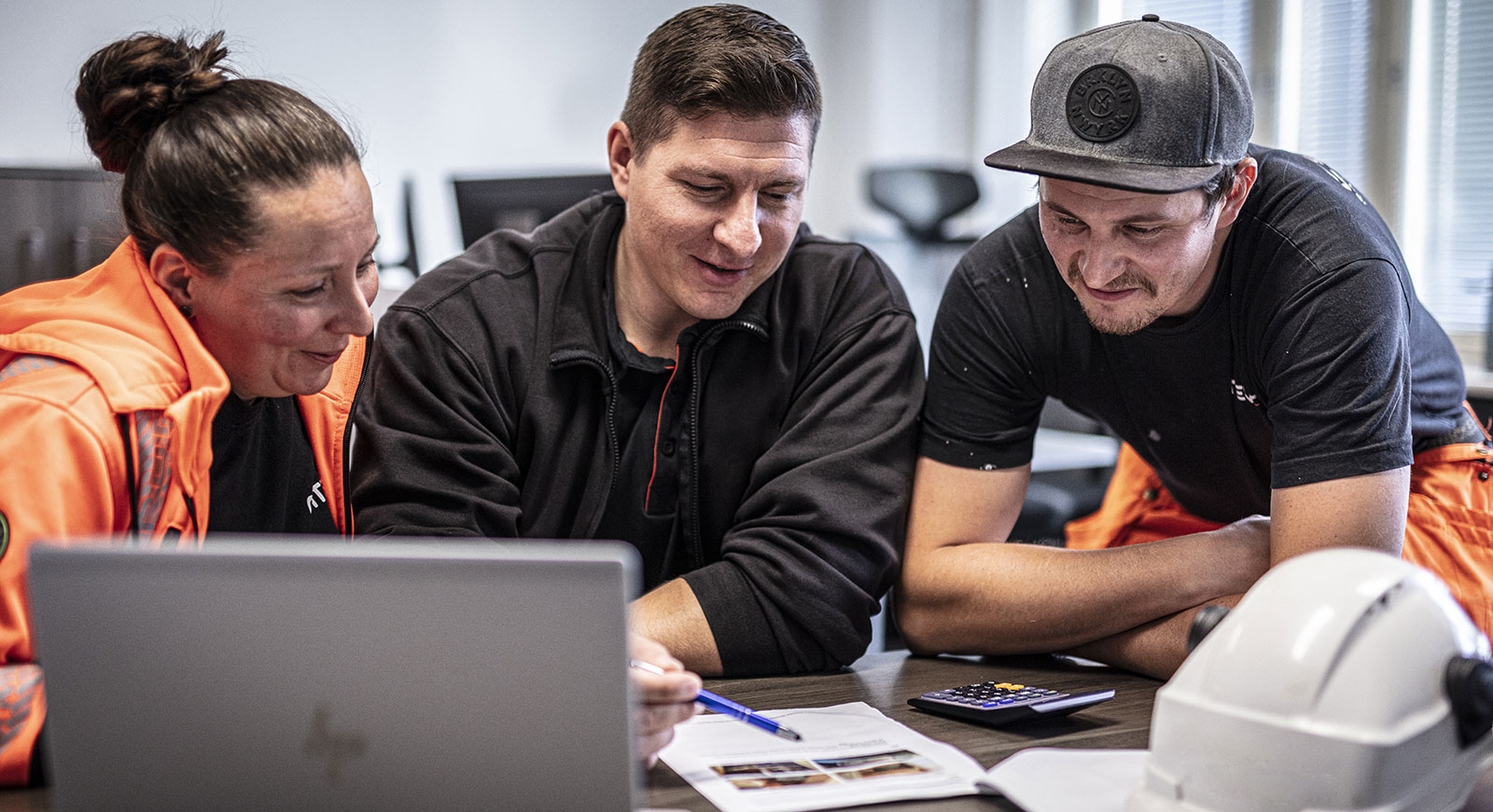 Three people planning in front of the computer