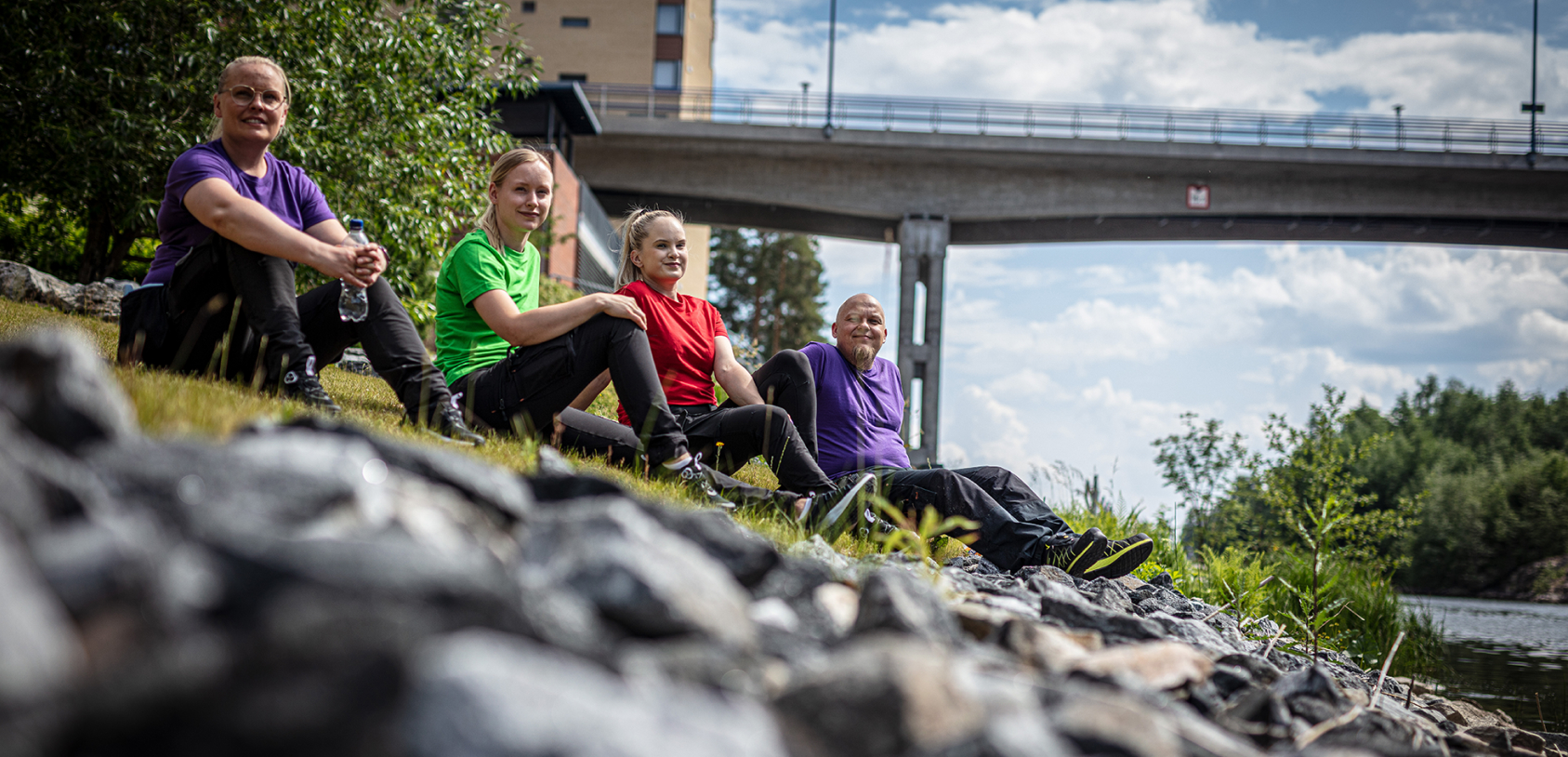 People are sitting on the river bank